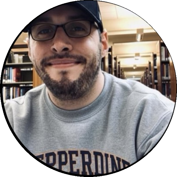 Bobby Alan in a Pepperdine sweatshirt in a library